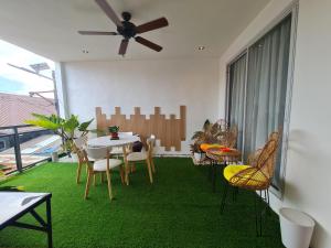 a dining room with a table and chairs and a ceiling fan at Hotel Pressie by SMS Hospitality in Panglao +19 photos