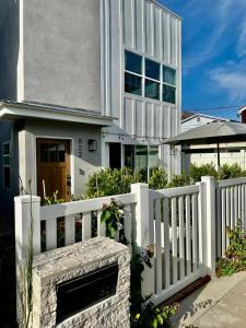 a white fence in front of a house at Location, location, location! 10 steps to the beach in San Diego