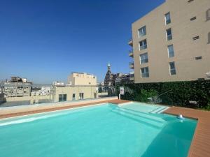 a large swimming pool on the roof of a building at Urban Luxury Studio Living in San Telmo num4649 in Buenos Aires