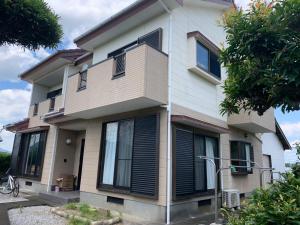 a house with black shutters on it at UMICHIKA HOUSE in Miyazaki