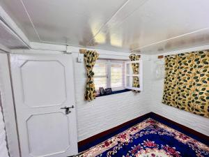 mały pokój z drzwiami i dywanem w obiekcie Dulal’s Homestay w mieście Godāvari