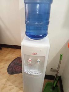 a bottle of water sitting on top of a water cooler at Bagobantay hostel in Manila