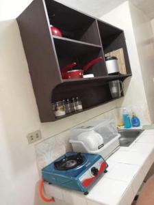 a kitchen with a toaster sitting on a counter at Bagobantay hostel in Manila