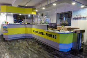 a kitchen with a yellow and blue counter top at Logis Hôtel Le Rochelois in La Rochelle
