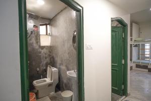 a bathroom with a toilet and a sink at Destin Olympus Banjara in Hyderabad