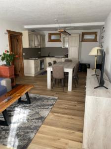 a kitchen and living room with a table and chairs at Old B&B in Cesiomaggiore
