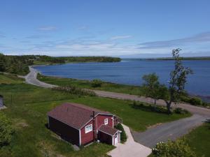 an aerial view of a house and a road next to a lake at Waterfront House near Pomquet Beach- 2 bedrooms, Pet-Friendly in Antigonish