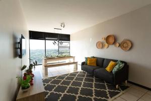 a living room with a couch and a table at Views from the Top in Edenvale