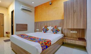 ein Schlafzimmer mit einem großen Bett in einem Zimmer in der Unterkunft FabExpress Prakash Inn in Mumbai