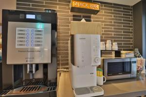 a coffee machine on a counter in a store at Hotel Yam Yeonsan in Busan