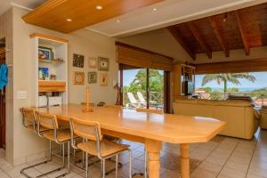 a dining room with a large wooden table and chairs at San Lameer Villa 14117 - 3 Bedroom Superior - 6 pax - San Lameer Rental Agency in Southbroom