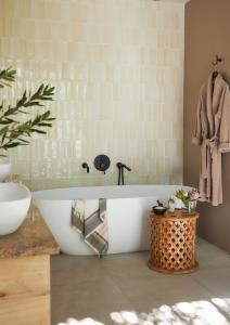 a bathroom with a tub and a sink at Kwandwe Private Game Reserve - Ecca Lodge in Grahamstown +35 photos