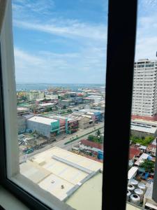a view of a city from a window at Aesthetic Functional Minimalist Space Sunvida Tower SV1716 in Cebu City