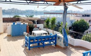 a blue bench on a balcony with a view of the water at House of Dreams apartments Luxor in Luxor