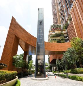 a clock tower in front of a building at Lucentia Residence BBCC Lalaport at Kuala Lumpur By Luxe Home in Kuala Lumpur
