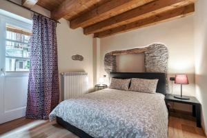 a bedroom with a large bed and a window at Residence V in Ponte di Legno