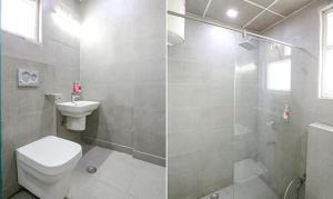 a bathroom with a toilet and a shower and a sink at FabHotel VT Paschim Vihar in New Delhi