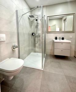 a bathroom with a shower and a toilet and a sink at MIRABELLE Homes in Salzburg