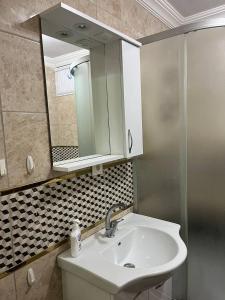 ein Bad mit einem Waschbecken und einem Spiegel in der Unterkunft Comfortable apartment with a balcony 9 in Yalova