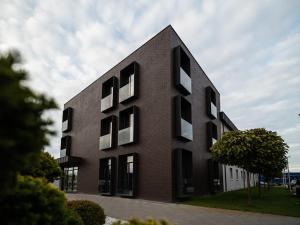 a black building with white windows on the side of it at Hotel MiraMar smart room in Kovelʼ