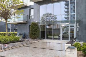 a building with a bike parked in front of it at Spacious Apartment Aleja Rzeczypospolitej with Balcony by Noclegi Renters in Gdańsk