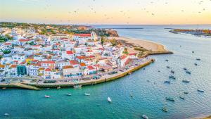 an aerial view of a city with boats in the water at Casa Eden in Ferragudo