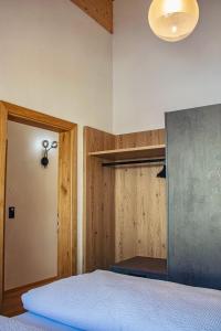 a bedroom with a bed and a light fixture at Apart. Oberhof in Gerlos