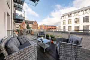 a balcony with couches and a table on a building at King Mindaugas Apartments in Kaunas