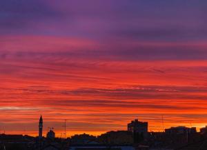 a sunset over a city with a red sky at Exphome in Novate Milanese