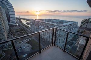 a view from the balcony of a building with the sunset at Gumbati Apart Hotel in Batumi