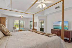 a bedroom with a large bed and a flat screen tv at Sunset Pass in Middleburg