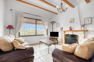 a living room with a couch and a fireplace at Villa up to 8 sleeps 4 bedrms 2 in Jávea