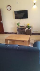 a living room with a blue couch and a coffee table at Ocean one apartment in Mombasa