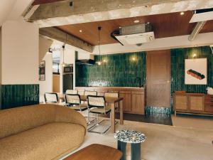 a living room with a couch and a table at illi Com Shimokitazawa in Tokyo