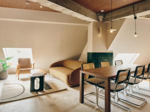 a living room with a table and chairs and a couch at illi Com Shimokitazawa in Tokyo
