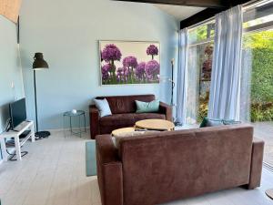 a living room with a couch and a table at Boerenslag 24 in Sint Maartensvlotbrug
