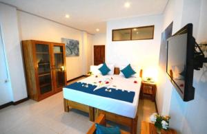 een slaapkamer met een bed in een kamer bij Hotel Sanset in Labuan Bajo