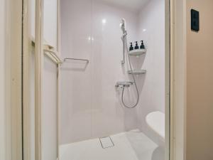 a bathroom with a shower with a glass door at illi Com Shimokitazawa in Tokyo