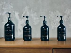 a group of four bottles sitting on a wooden table at illi Com Shimokitazawa in Tokyo