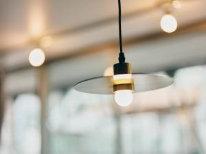 a ceiling fan in a room with lights at illi Com Shimokitazawa in Tokyo