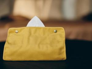 a yellow purse with a white paper sticking out of it at illi Com Shimokitazawa in Tokyo