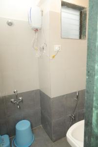 a bathroom with a shower with a toilet and a sink at Antique Home Stay in Daman