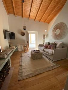 a living room with a couch and a table at Casa da Corredoura in Évora