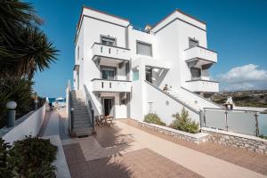a white building with stairs leading up to it at Blue Pearl Apolakkia 2 in Apolakkiá
