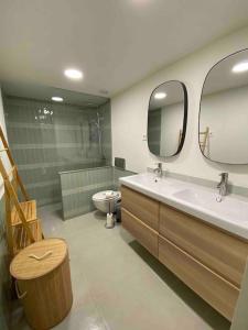 a bathroom with a sink and a toilet and a mirror at Casa da Corredoura in Évora