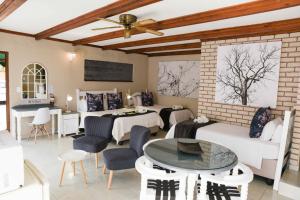 a living room with a couch and a table at Greenfields Guesthouse & Restaurant in Alberton