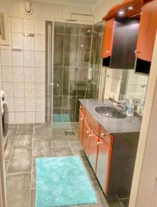 ein Bad mit einer Dusche, einem Waschbecken und einem Spiegel in der Unterkunft Lovely House in Tromso with amazing wiev in Tromsø