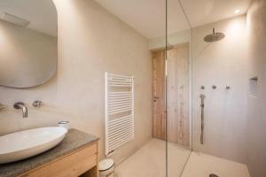 a bathroom with a sink and a shower at Karerhof in Nova Levante