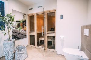 a bathroom with a toilet and a sink at Boutique ChaletS Alpi - Private Sauna & Cinema in Garmisch-Partenkirchen