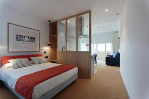 a bedroom with a large bed and a large glass wall at Hotel Miramar Valencia in Valencia